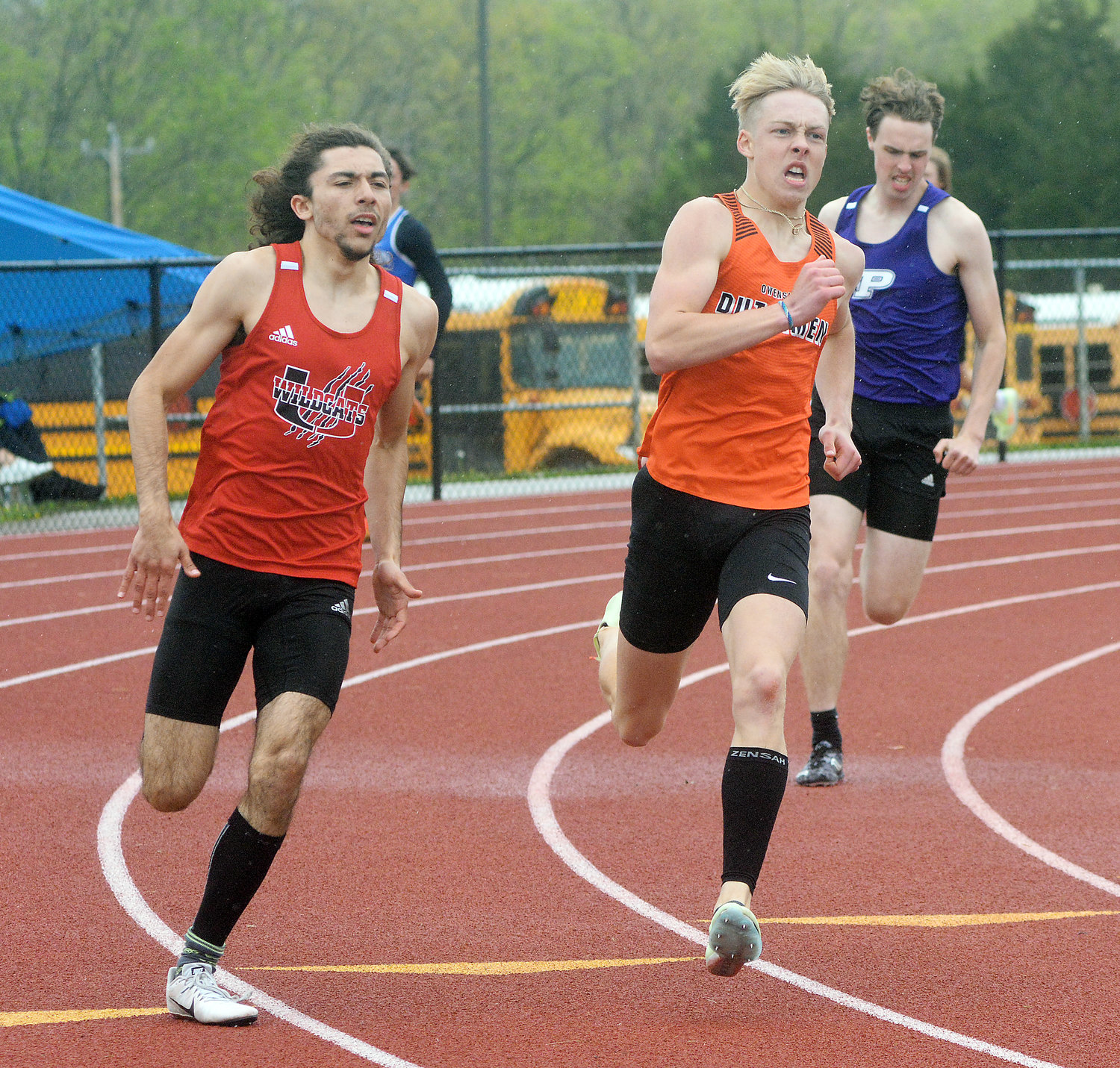 Jacob Breedlove (center) turns the corner for the home stretch before edging Union’s Elias Neely for the FRC title in the varsity boys 400-meter dash.